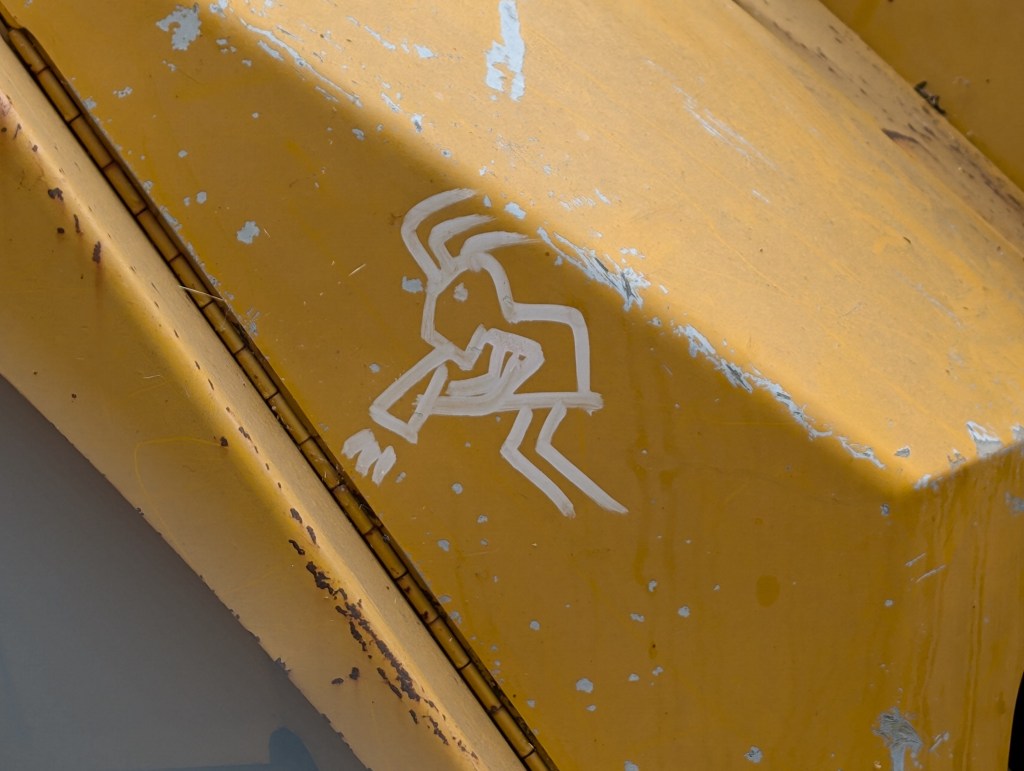Kokopelli on a backhoe